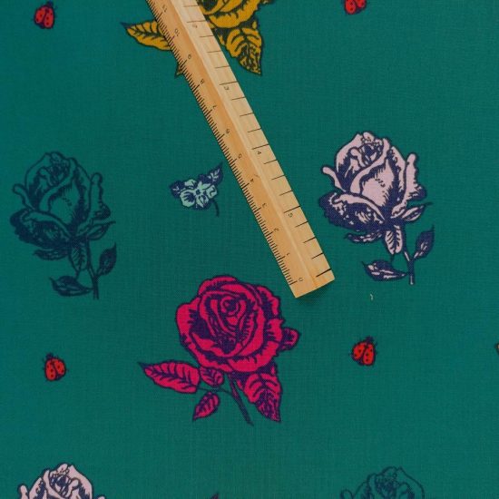 Imprimé floral pour ce tissu Nathalie Lété une rose dessinée au trait comme celle de la belle au bois dormant rose fuschia sur fond vert sapin